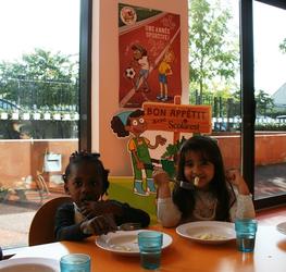 Enfants à table au restaurant scolaire 